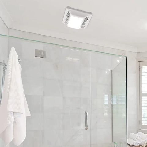 Super Quiet 90 CFM Bathroom Exhaust Fan With Built In LED Light, installed on a bathroom ceiling with white grill, 1 sone noise level.