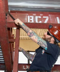 Worker using Ergonomic Round Connecting Bar 7/8 Inch Wide By 30 Inch Long With 15 Degree Angled Chisel on steel beam