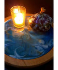 Acacia Lazy Susan With Blue Resin Art, 10 Inch Turntable With Resin Finish For Kitchen Cabinets, Pantry Or Table Organization shown with candle