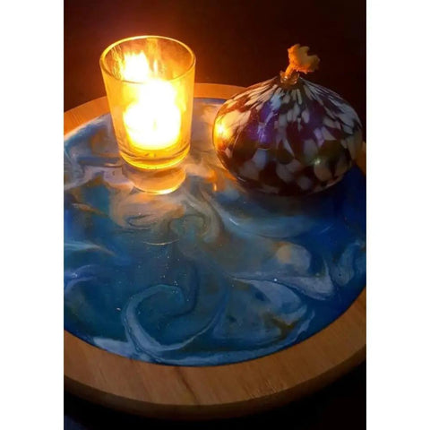 Acacia Lazy Susan With Blue Resin Art, 10 Inch Turntable With Resin Finish For Kitchen Cabinets, Pantry Or Table Organization shown with candle