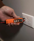 Person using Ultra Handy Digital AC DC Voltage Tester For 12 To 240V AC And 32 To 330V DC With Bright LED Indicator on an outlet
