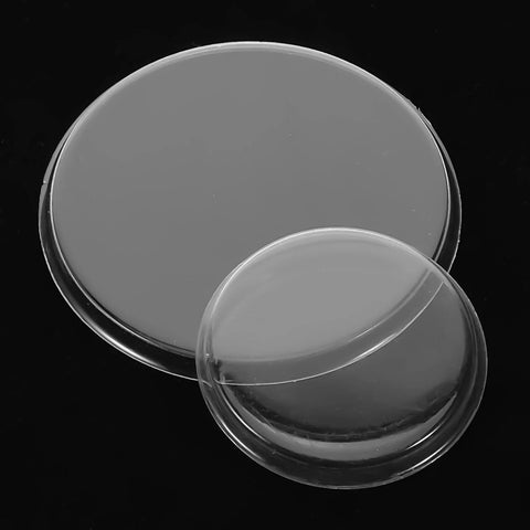 Two clear plastic stethoscope diaphragms, large and small, replacement accessories for pediatric and adult use.