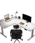Electric Height Adjustable L Shaped Standing Desk With Smooth Dual Motors For Home Office Corner Setup with laptop and monitor.