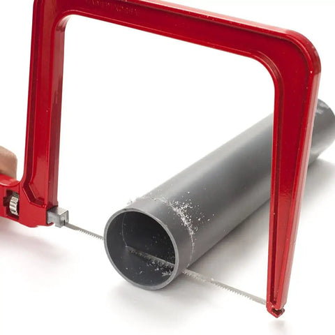 Heavy Duty Frame Coping Saw With Five Interchangeable Blades For Cutting Wood Metal Plastic Rods And Pipes Straight Up Built To Last, cutting through a PVC pipe.
