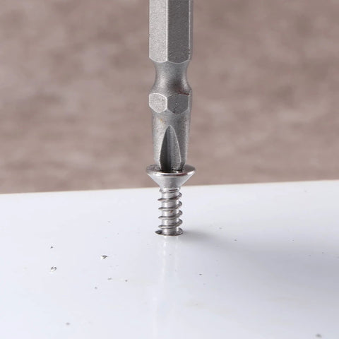Close-up of Number Ten By One And A Half Inch Sheet Metal Screw being installed in surface, showing stainless steel finish.