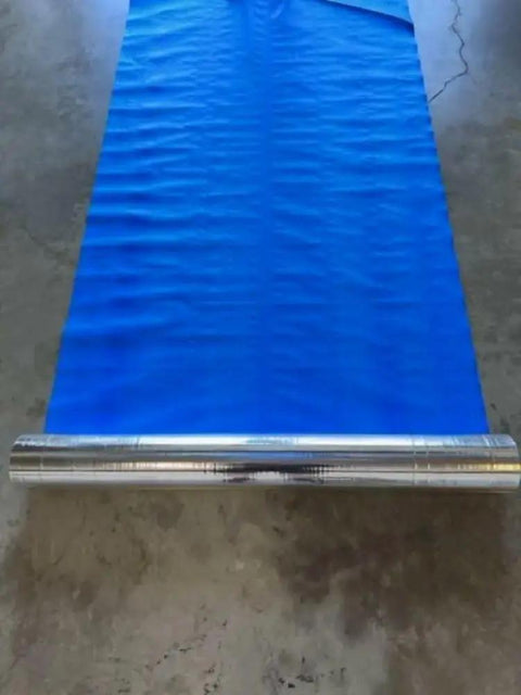 Four By Two Hundred Fifty Foot Synthetic Roof Underlayment Pro Grade Heavy Slick Roll shown on a flat surface, blue mat unrolled.