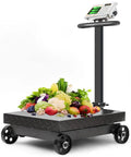 Heavy Duty Foldable Digital Floor Scale With Crisp HD LCD Display Rechargeable Battery For Luggage And Shipping Packages 660 Pound Capacity with fruits and vegetables on stainless surface.
