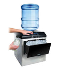 Smooth Operator Countertop Ice Maker Churns Out Twenty Five Kilograms Of Bullet Ice Daily In Just Twelve Minutes With Hassle Free Touch Controls, hands filling glass with ice.
