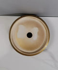 Top view of round golden bathroom sink vessel, showing shiny finish and black drain hole, elegant for modern bathrooms.