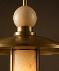 Close-up of Modern Brass Pendant Chandelier Light Fixture with Alabaster Cylinder Shade Luxury Natural Stone Hanging Ceiling Light with Spherical Marble Accent for Kitchen Dining Room, Bar & Living Room Set of 3.