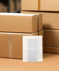 100 Pcs White EPE Foam Packing Pouches For Shipping And Storage displayed in front of stacked cardboard boxes.