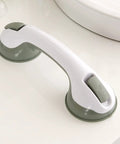 Green and white suction grab bar on bathroom counter.