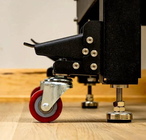 Side view of Heavy Duty Steel Caster Set For Router Tables, Workbenches, Cabinets And Tool Stands With 800 LB Capacity, installed.