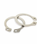 Close-up of two stainless steel 304 circlips for Pro Grade C Type External Circlip Kit 750 Pieces M6 To M15 For Shaft Bearings Locking Gears On Shafts.
