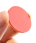 Round Math Counters Set, durable plastic counting chip in red and yellow held between fingers, vividly colored for easy visibility.