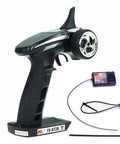 FS-GT2B 2.4GHz 3 Channel RC Transmitter With FS-GR3E Receiver For RC Cars And Boats, showing handheld device and receiver.