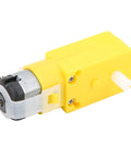 Yellow Mecanum wheel module for geared motor with metal DC motor and clear guard.