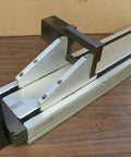 Single Pre-owned Robotic Linear Unit, Precision Automation Guide Rail with Slide Block on a wooden surface, used motion stage for automation.