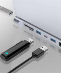 Close-up of USB devices connected to a laptop showcasing ports for Level Up Your Gear Game With This Heavy Duty 12 In 1 Type C Hub Docking Station.
