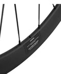 Close-up of 50mm and 23mm carbon road wheelset 700c clincher for Shimano 8 9 10 11 speed with basalt brake surface.