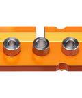 3 In 1 Aluminum Dowel Jig For Woodworking Features Built In Midpoint Alignment For Dead Center Hits, orange anodized jig with metallic bushings.