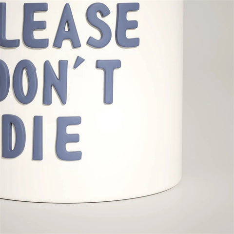 Close-up of white planter with the phrase 'PLEASE DON'T DIE' in raised blue letters.