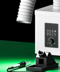 Compact Desktop Solder Fume Extractor With Dual Stage Air Purifier beside soldering iron holder, showcasing control panel and exhaust hose.