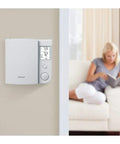 Five Two Day Programmable Thermostat For Electric Baseboard Heaters With Ultra Accurate Temperature Control mounted on wall