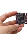 Hand holding a Flight Controller With Five Serial Ports 5V And 9V BEC Output OSD And 16MB Flight Recorder For RC Drones And Model Airplanes
