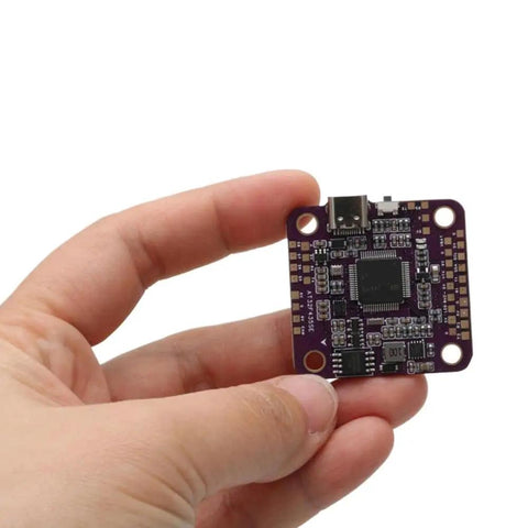 Hand holding a Flight Controller With Five Serial Ports 5V And 9V BEC Output OSD And 16MB Flight Recorder For RC Drones And Model Airplanes