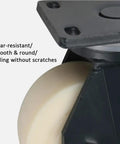 Heavy Duty Eight Inch Nylon Swivel Casters Built Beefy With Carbon Steel Bearings And A Riveted Base For Crush Proof Performance. Close-up of smooth white nylon wheel.