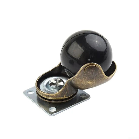 Four Pack Of 1.5 Inch Gold Ball Caster Wheels For Sofas And Ottomans Featuring Smooth 360 Degree Swivel Casters To Roll Furniture Around Home Without Breaking A Sweat Or Scratching Floors Ever - close-up of a gold swivel caster with a black ball.
