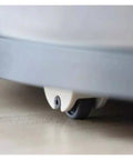 Four Pack Self Adhesive Directional Caster Wheels For Kitchen Cabinets Drawer Units And Storage Bins view of caster wheel underside on floor.