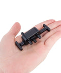 Person holding a small black aluminum beefed up metal transfer case with reverse shaft for 1/10 LCG RC crawler SCX10 chassis upgrade parts.