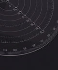 Close-up of LANRU round center finder compass, clear acrylic circle gauge with concentric scales and drilled holes