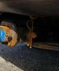 Close-up of a rusted 5/8 inch by 4.25 inch trailer hitch pin, installed on a vehicle, showing corrosion on zinc plating and pin.