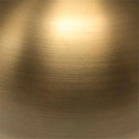 Close-up of brushed brass finish on Go To 68 Inch Tall Arc Floor Lamp With Glass Shade In Brushed Brass And Milk White