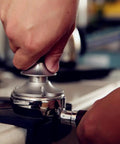 Top Tier 51mm Stainless Steel Coffee Tamper With Adjustable Calibration And Anti Deviation Base For Consistent Espresso Compaction in use.