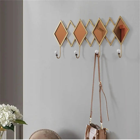 Real Deal Nordic Wrought Iron Wall Hooks For Coats And Keys Heavy Duty Build. Features decorative diamond shapes and white knobs.