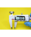 Digital caliper measuring 9.00mm displayed on a bright yellow background for precision measurement.