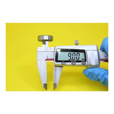 Digital caliper measuring 9.00mm displayed on a bright yellow background for precision measurement.
