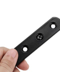Eight Piece Stainless Steel Mending Plates 4 Inch Square Corner Brackets With Matching Screws For Heavy Duty Furniture Repair And Quick Fixes Built Rock Solid No Hassle Design Black Finish Secure Grip, black metal plate held in hand.