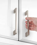 Hand holding 10 Pack 5 Inch Brushed Nickel Kitchen Cabinet Pulls on white cupboard, Silver Nickel Hardware for Cabinets, Drawers, Dresser