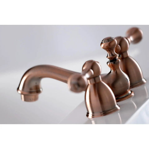 Model KS3952AL Restoration Mini Widespread Lavatory Faucet with metal lever handles polished brass finish on white basin