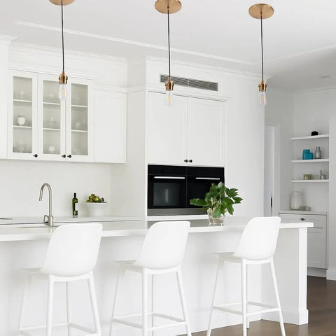 Slick Six Inch Recessed Can To Instant Pendant Light Conversion Kit In Top Shelf Satin Brass Finish with E26 Socket over kitchen island.