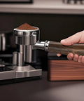 Boss Level 58mm Bottomless Portafilter With Genuine Black Walnut Handle For Breville Models with ground coffee ready for use.