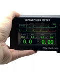 Hand holding a High Precision Digital Standing Wave Meter for Ham Radio Buffs with 5W to 200W Power Meter and SWR Readout.