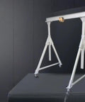 Portable Electric Winch And Aluminum Alloy Gantry Crane With Adjustable Chain Ratchet Hoist System and Manganese Steel Hook on a gray background.
