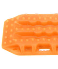 Close-up of orange plastic RC sand ladder with traction spikes, part of Sand Ladder For RC Cars Off Road Recovery Ramps 2 pack for 1/24 and 1/18 scale.