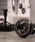 58mm Espresso Wdt Tool Dial Into Your Shot Game And Keep Grinding Strong With 14 Precision Needles lying on a counter.